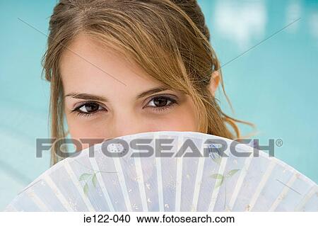 Young woman with fan View Large Photo Image Stock Image - Young woman with fan. Fotosearch