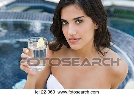 Young woman with glass of water View Large Photo Image Stock Image - Young woman with glass of water. Fotosearch