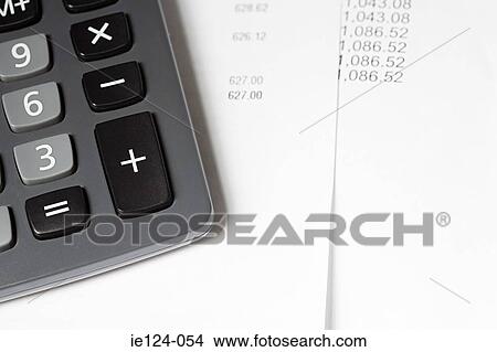 A calculator and paper work View Large Photo Image Picture - A calculator and paper work. Fotosearch