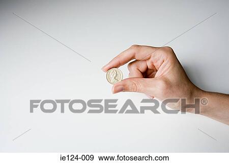 A person holding a pound coin View Large Photo Image Stock Photo - A person holding a pound coin. Fotosearch