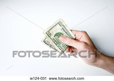 A person holding a ten dollar note View Large Photo Image Stock Image - A person holding a ten dollar note . Fotosearch