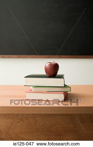 Apple on pile of books View Large Photo Image Stock Photo - Apple on pile of books. Fotosearch