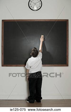 Stock Photography - Boy cleaning blackboard. Fotosearch