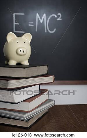 Piggy bank and pile of books View Large Photo Image Stock Image - Piggy bank and pile of books. Fotosearch