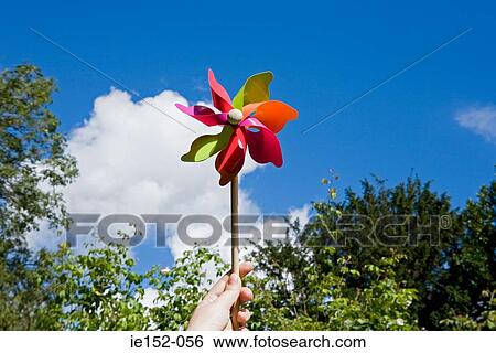 A person holding a pinwheel View Large Photo Image Stock Photograph - A person holding a pinwheel. Fotosearch