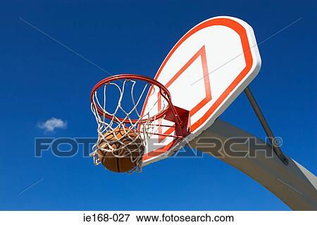 Basketball going through hoop View Large Photo Image Stock Photo - Basketball going through hoop. Fotosearch
