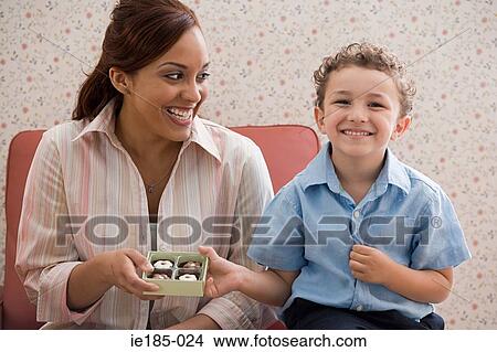 Picture - Boy giving chocolates to mother. Fotosearch