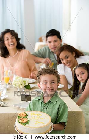 Stock Image - Family and boy with cake. Fotosearch