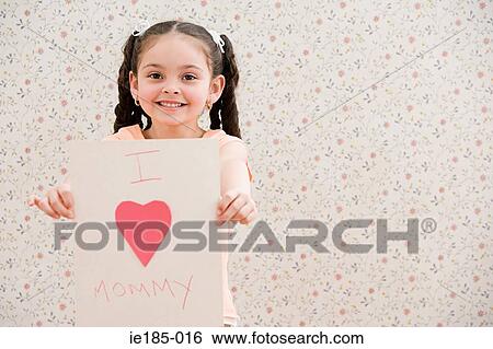 Girl holding a card View Large Photo Image Stock Photograph - Girl holding a card. Fotosearch