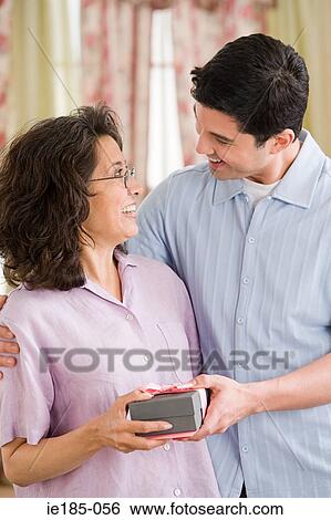 Stock Photograph - Man with gift for mother. Fotosearch
