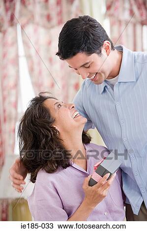 Son giving gift to mother View Large Photo Image Stock Image - Son giving gift to mother. Fotosearch