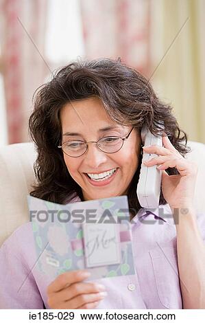 Woman on telephone with card View Large Photo Image Stock Photo - Woman on telephone with card. Fotosearch
