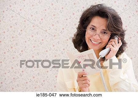 Woman on telephone with card View Large Photo Image Stock Photo - Woman on telephone with card. Fotosearch