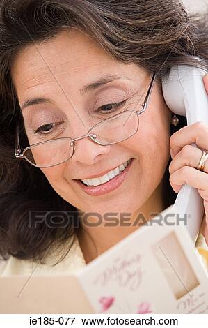 Woman with telephone and card View Large Photo Image Stock Photo - Woman with telephone and card. Fotosearch