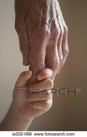 Stock Photo - A child holding a womans hand. Fotosearch