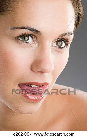 A woman licking her lips View Large Photo Image Stock Photo - A woman licking her lips. Fotosearch