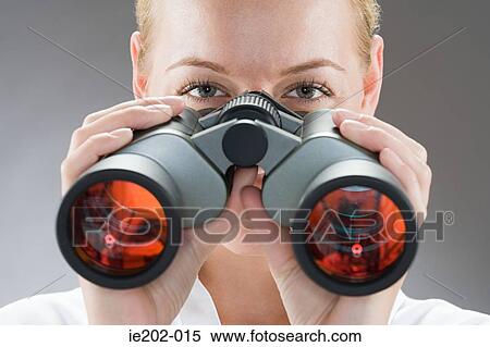A woman looking through binoculars View Large Photo Image Stock Photography - A woman looking through binoculars. Fotosearch
