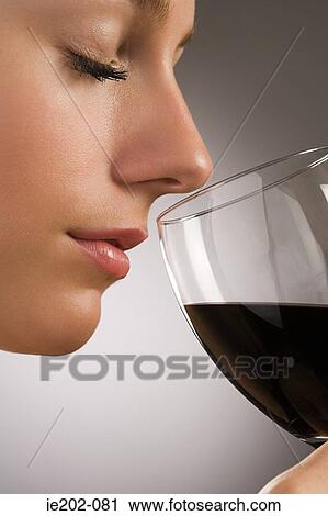 A woman smelling red wine View Large Photo Image Stock Image - A woman smelling red wine. Fotosearch
