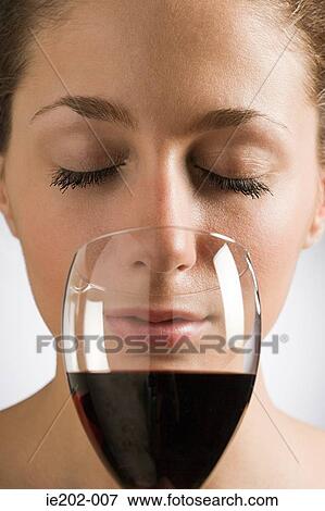 A woman smelling red wine View Large Photo Image Stock Photo - A woman smelling red wine. Fotosearch