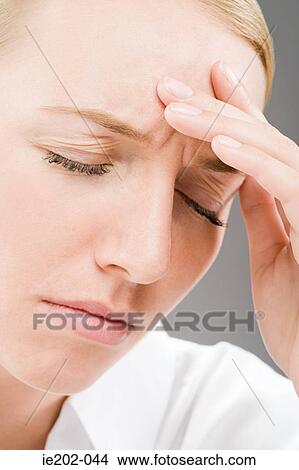 A woman touching her head View Large Photo Image Picture - A woman touching her head. Fotosearch
