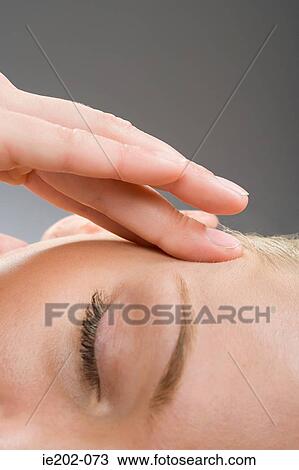 A woman touching her head View Large Photo Image Stock Image - A woman touching her head. Fotosearch