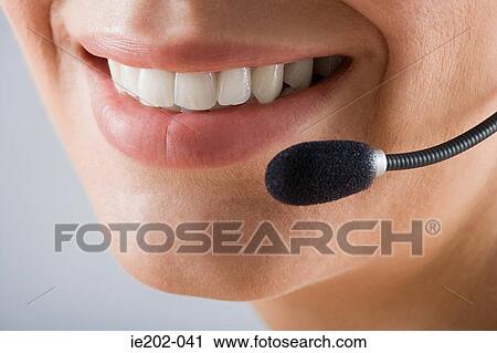 Stock Image - A woman wearing a headset. Fotosearch
