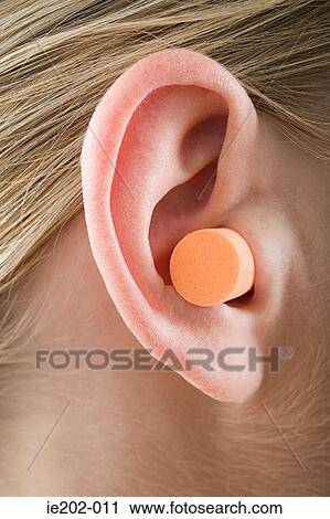 A woman wearing an ear plug View Large Photo Image Stock Image - A woman wearing an ear plug. Fotosearch