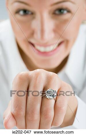 A woman wearing an engagement ring View Large Photo Image Stock Photo - A woman wearing an engagement ring. Fotosearch
