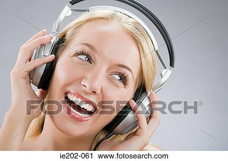 Stock Image - A woman wearing headphones. Fotosearch