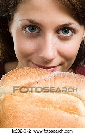 Portrait of a woman smelling bread View Large Photo Image Stock Image - Portrait of a woman smelling bread. Fotosearch