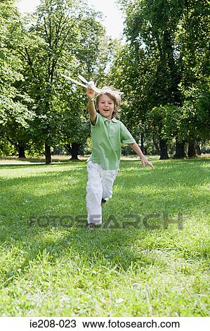 Stock Image - Boy with a toy aeroplane. Fotosearch