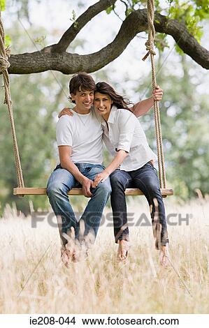 Picture - Couple on a swing. Fotosearch