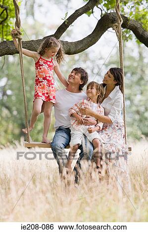 Stock Photograph - Family on a swing. Fotosearch