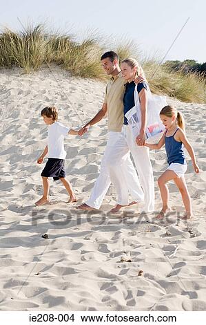Family walking on beach View Large Photo Image Picture - Family walking on beach. Fotosearch