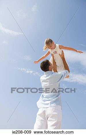 Father lifting daughter View Large Photo Image Stock Photo - Father lifting daughter. Fotosearch