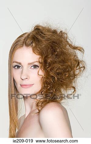 Stock Photo - A woman with straight and curly hair. Fotosearch