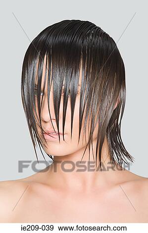 A woman with wet hair covering her face View Large Photo Image Stock Photo - A woman with wet hair covering her face. Fotosearch