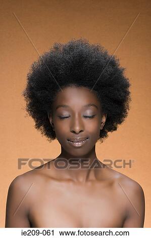 Stock Image - Portrait of a woman with afro hair. Fotosearch