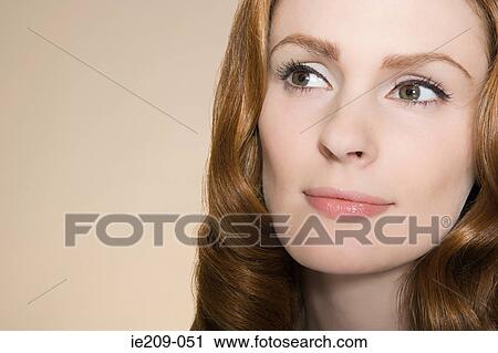 Stock Image - Portrait of a woman with ginger hair. Fotosearch