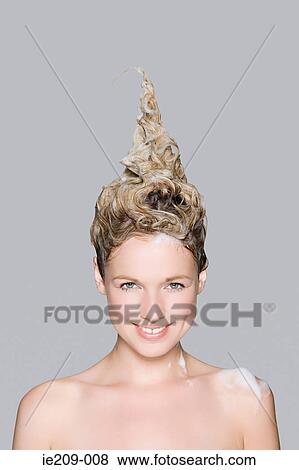 Stock Photo - Portrait of a woman with shampoo in her hair. Fotosearch