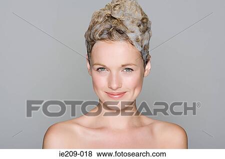 Stock Photo - Portrait of a woman with shampoo in her hair. Fotosearch