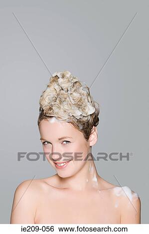 Stock Photograph - Portrait of a woman with shampoo in her hair. Fotosearch
