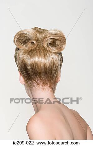 Stock Image - Rear view of a woman with a hairstyle. Fotosearch