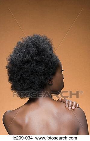 Picture - Rear view of a woman with afro hair. Fotosearch