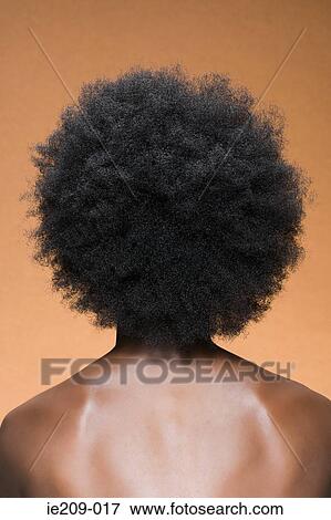 Stock Photo - Rear view of a woman with afro hair. Fotosearch