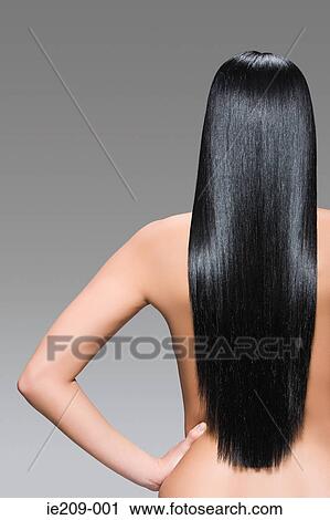 Rear view of a woman with long hair View Large Photo Image Stock Image - Rear view of a woman with long hair. Fotosearch