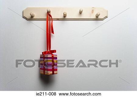 A christmas present hanging from a hook View Large Photo Image Stock Photo - A christmas present hanging from a hook. Fotosearch
