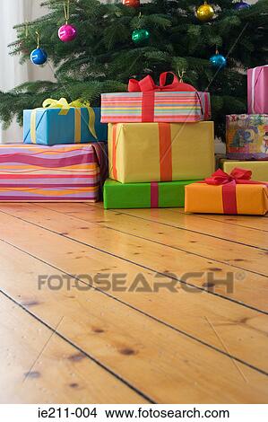 Picture - Christmas presents under the tree. Fotosearch
