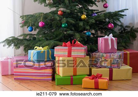 Christmas presents under the tree View Large Photo Image Stock Photo - Christmas presents under the tree. Fotosearch