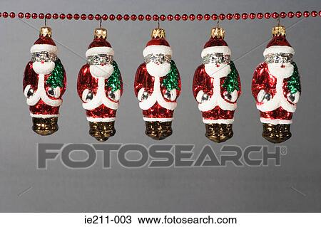 Santa claus decorations hanging in a row View Large Photo Image Stock Image - Santa claus decorations hanging in a row. Fotosearch